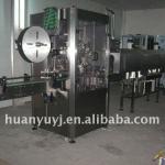 Automatic bottle shrinking and labeling machine