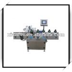 Self adhesive bottle labeling machine