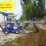 Towable backhoe with engine