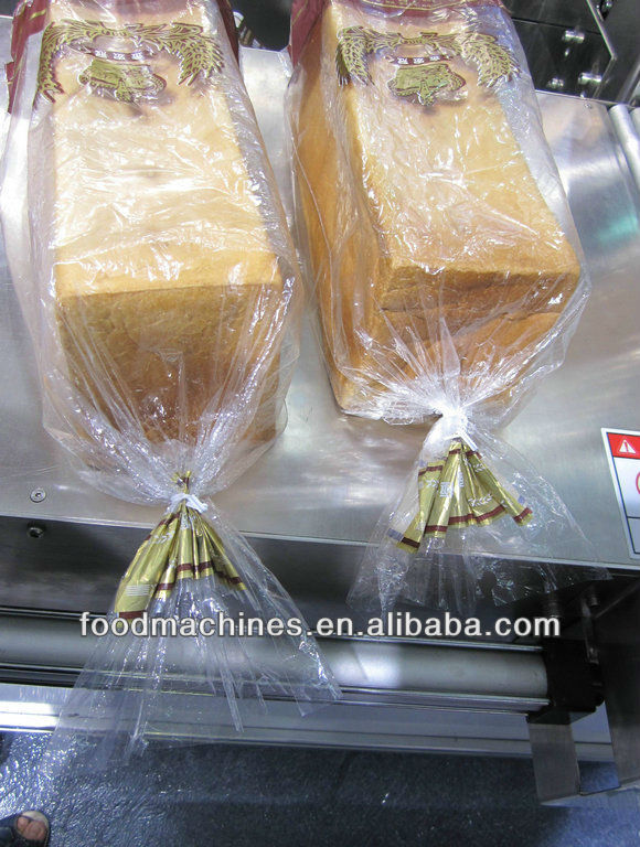 Automatic bread cutting and twist packing machine