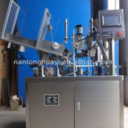 Automatic tube filling and sealing machine